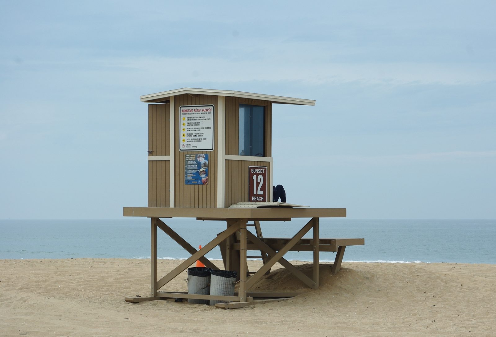 Lifeguard station 12 at Sunset Beach, its side posted with a beach hazards warning. The weather service advises staying out of the water, or staying near occupied lifeguard towers, while the statement is in effect.