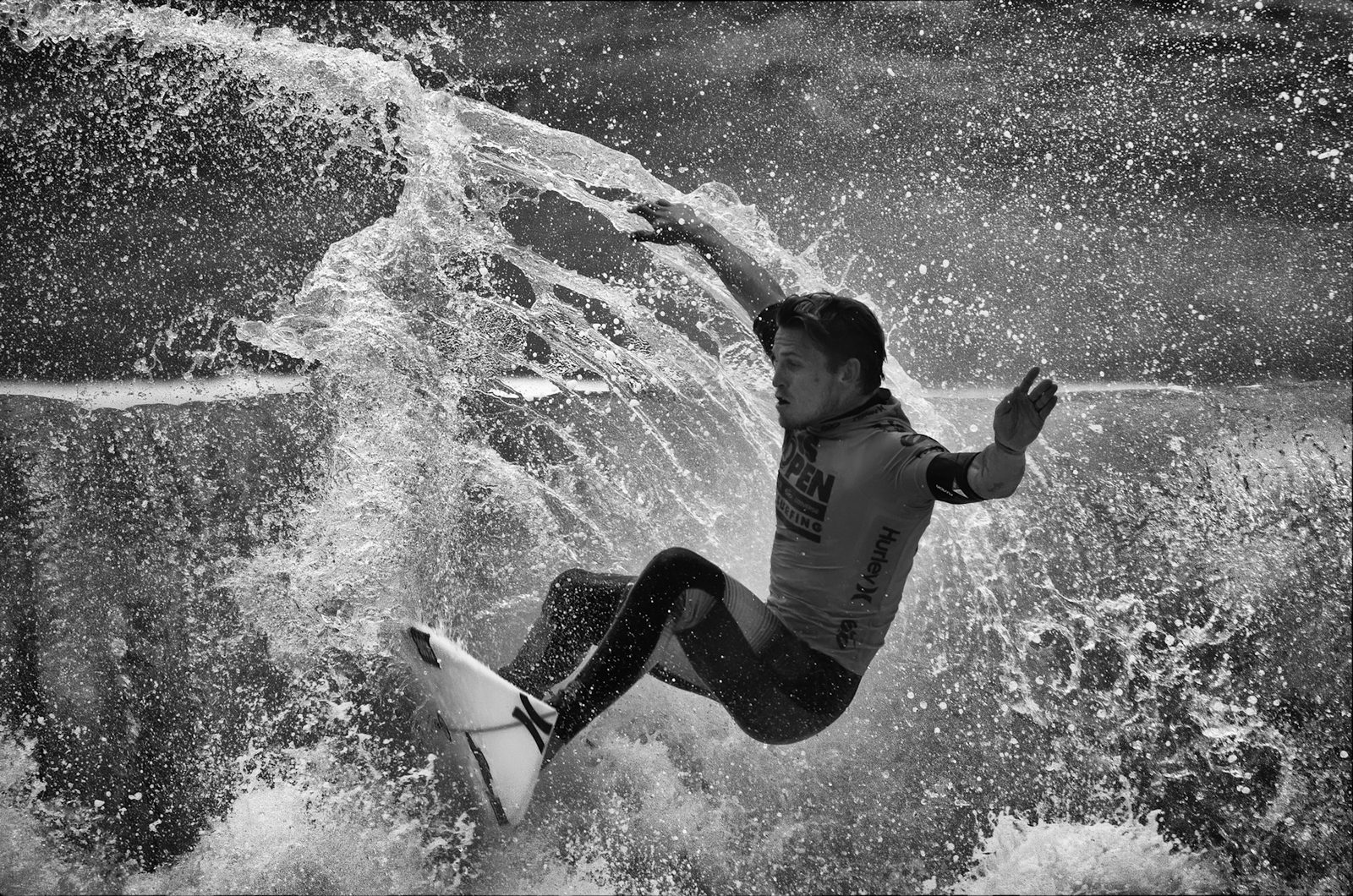 File photo: a competitor carves through a wave during the U.S. Open of Surfing at Huntington Beach. Rip currents can pull swimmers and surfers out to sea, the weather service said.