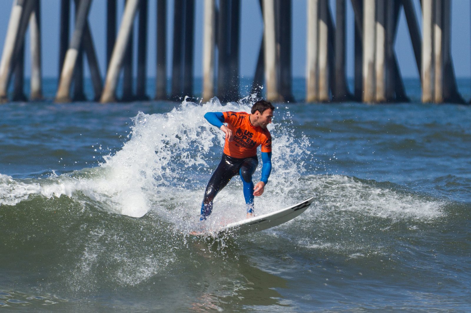 File photo: a competitor rides beside the Huntington Beach Pier during the U.S. Open of Surfing. A Great Day in the Stoke brought 65 competitors to the pier break on Saturday.