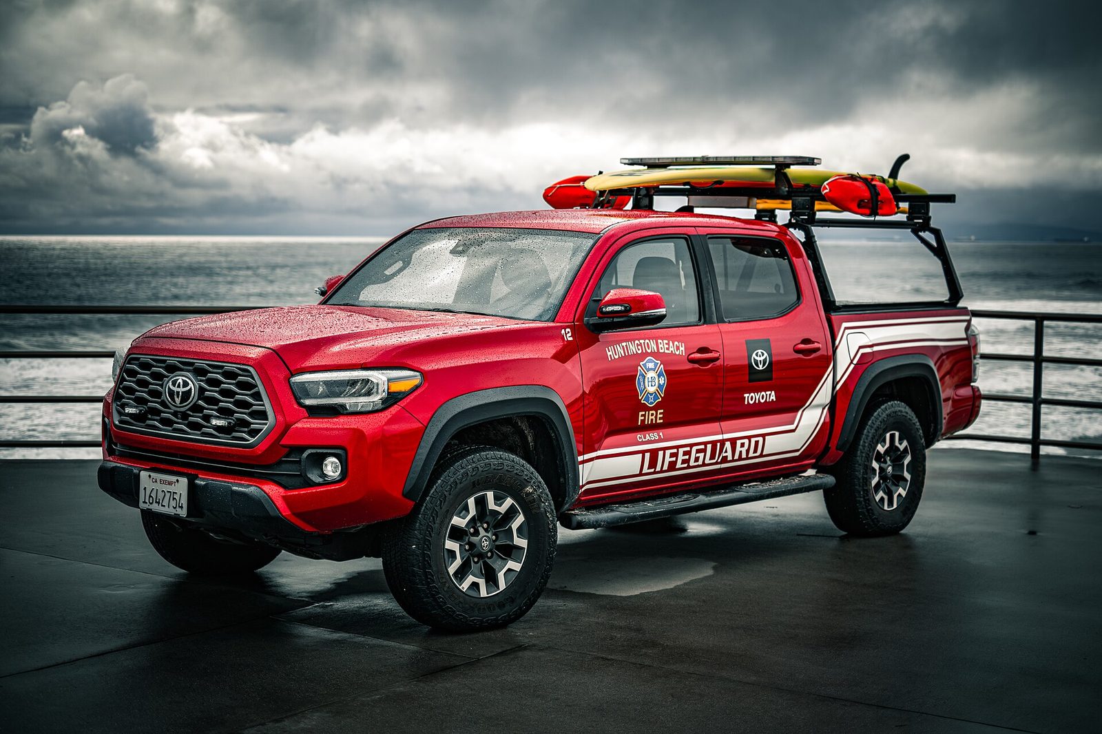 File photo: A Huntington Beach Fire Department lifeguard truck on the pier, rescue boards racked on top. Beach crews and beachgoers face a forecast high of 88 degrees on Saturday under a heat advisory that runs through 8 p.m.