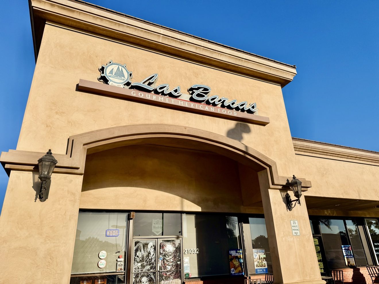 The Las Barcas storefront at 21032 Beach Blvd in Huntington Beach. The ship’s-wheel sign above the door reads "Since 1987".