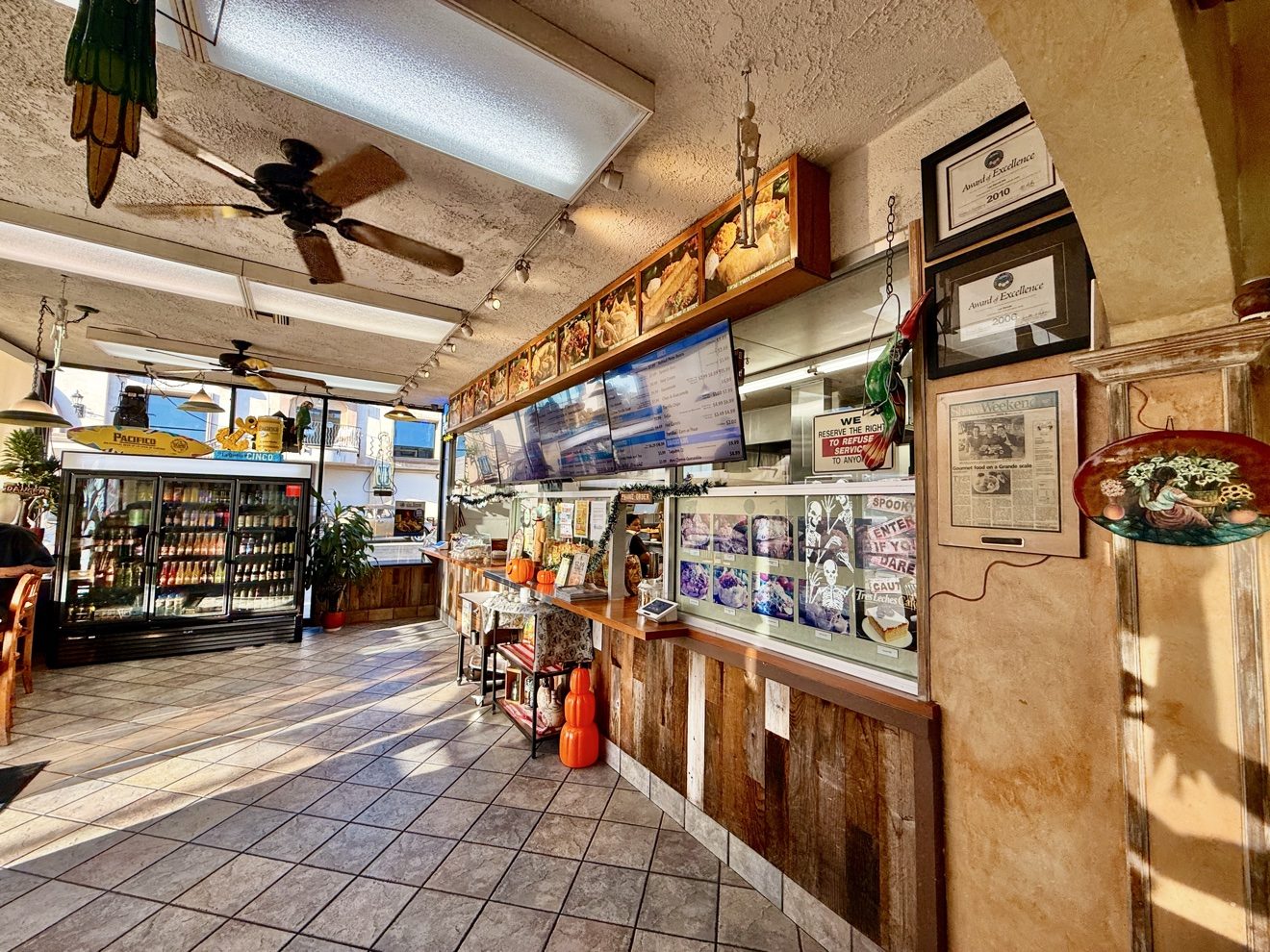 Inside Las Barcas on Beach Boulevard: the order counter, menu boards, dining room and framed awards. The family-owned restaurant has operated in Huntington Beach since 1987.