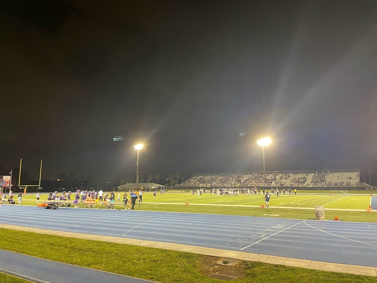 A high school football game under the lights in Miami. Huntington Beach had won its first four games by double digits.
