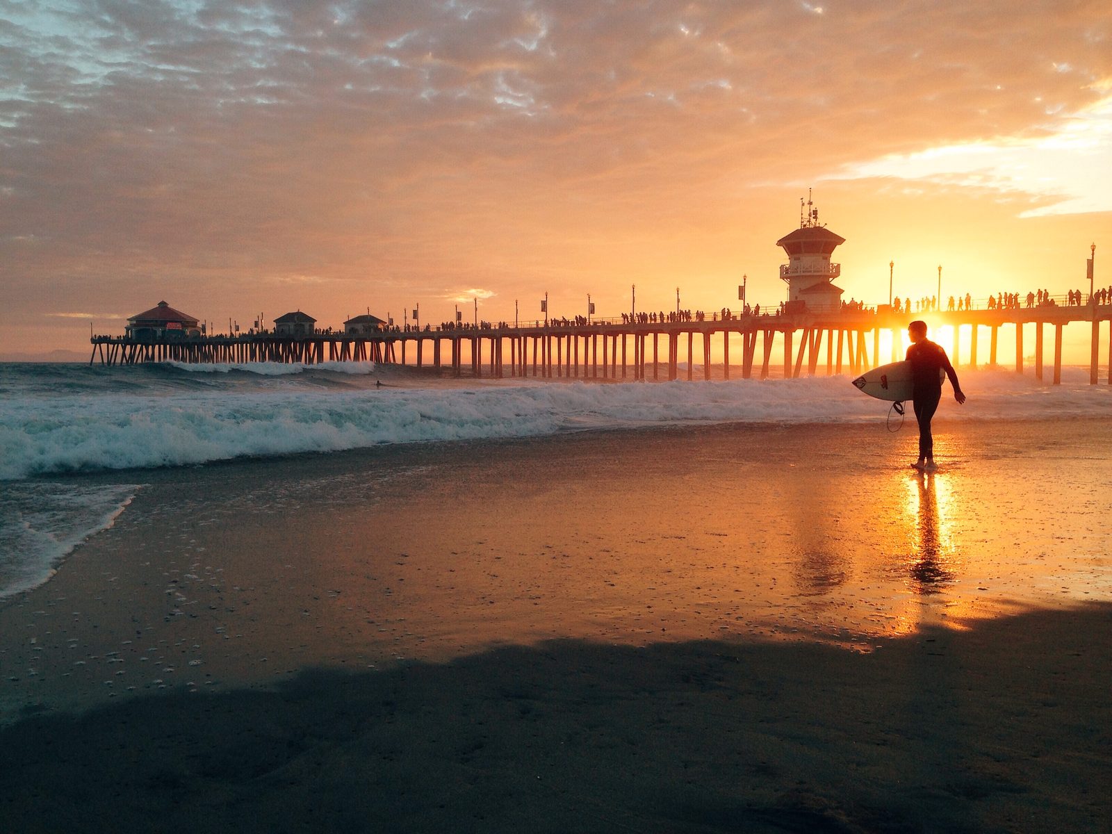 Whitewater crashes around the Huntington Beach Pier at sunset. Post-Tropical Cyclone Rachel moved onshore in northern Baja California early Sunday morning.