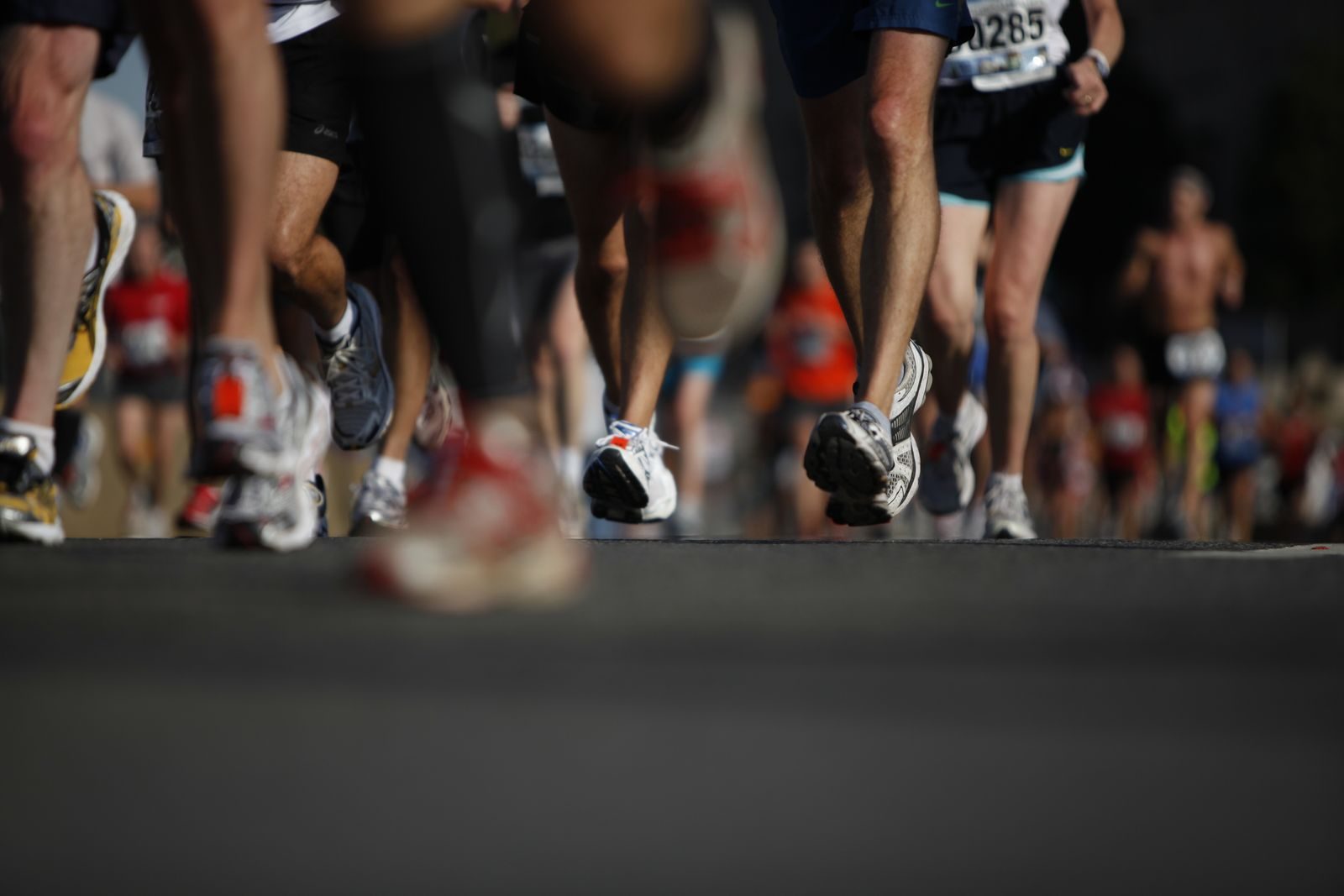 Runners stream out of the starting corral at a marathon. A record 10,000 runners took over Pacific Coast Highway for the 70th Surf City 10.