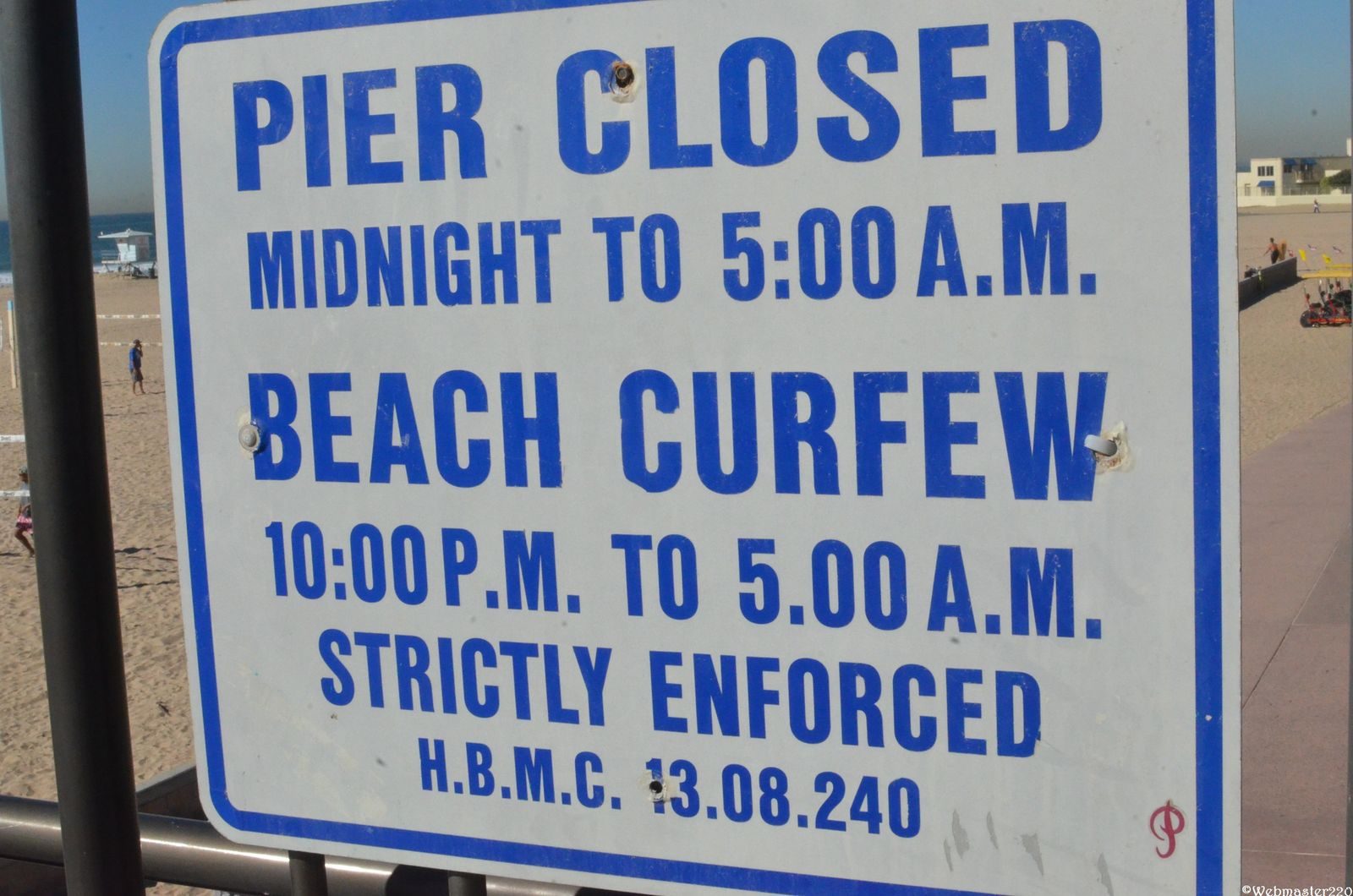 The official hours sign at the Huntington Beach Pier. Building or remodeling near the water means answering one question first: who issues the permit?